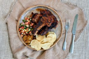 Tandoori spiced lamb chops grilled and rested, served with kachumber salad of tomato, cucumber, red onion and coriander, alongside pappadums and lime pickle